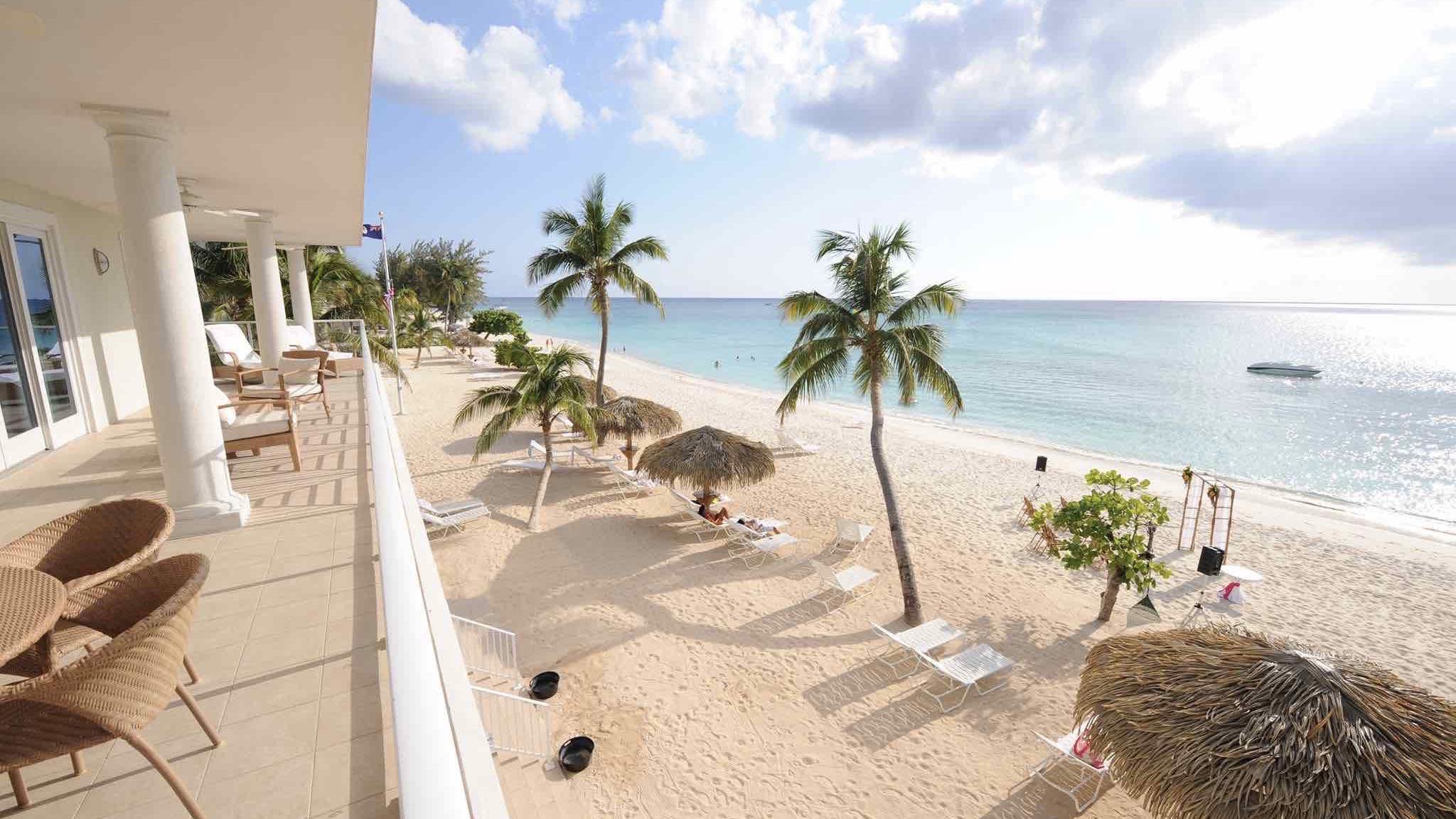Caribbean Club balcony view over beach at one of the best luxury hotels in Cayman Islands